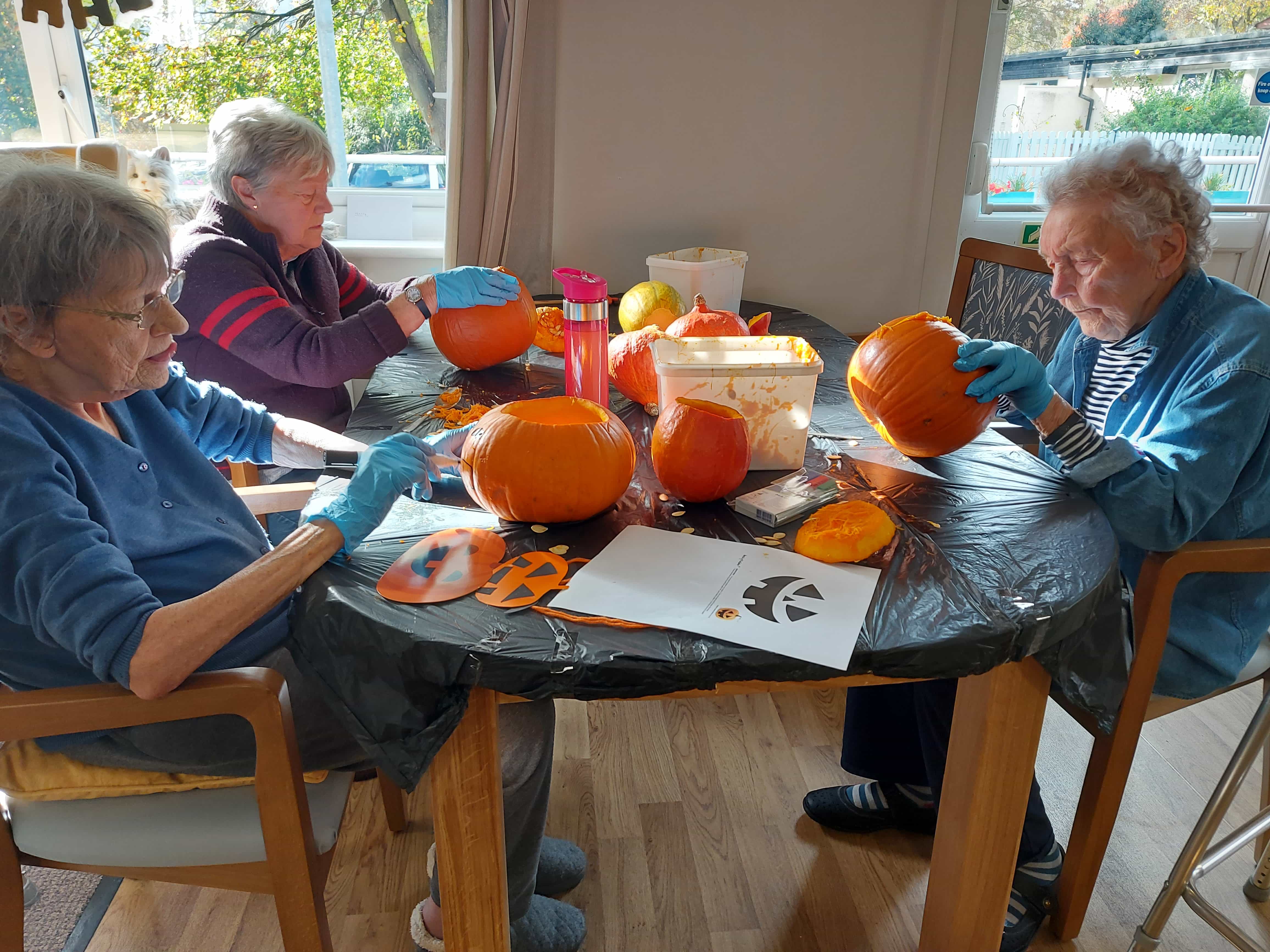 residents carving pumpkins 