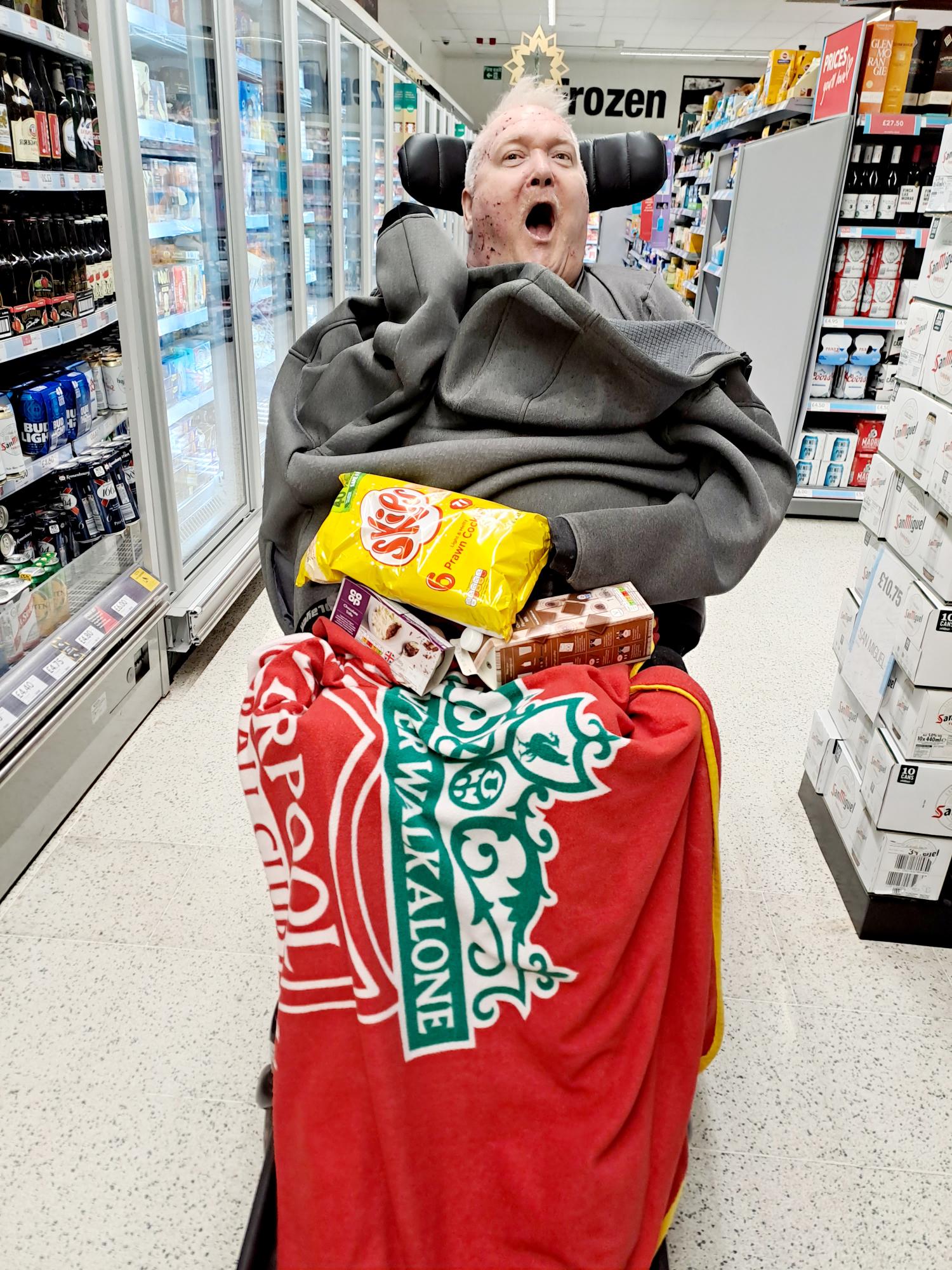 Dave in the shop with his snacks