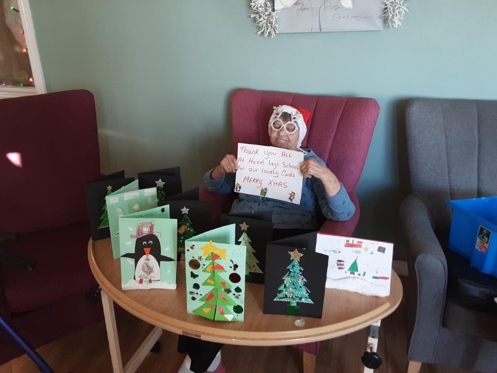 resident with a sign saying thankyou to Hazel Leys Primary School