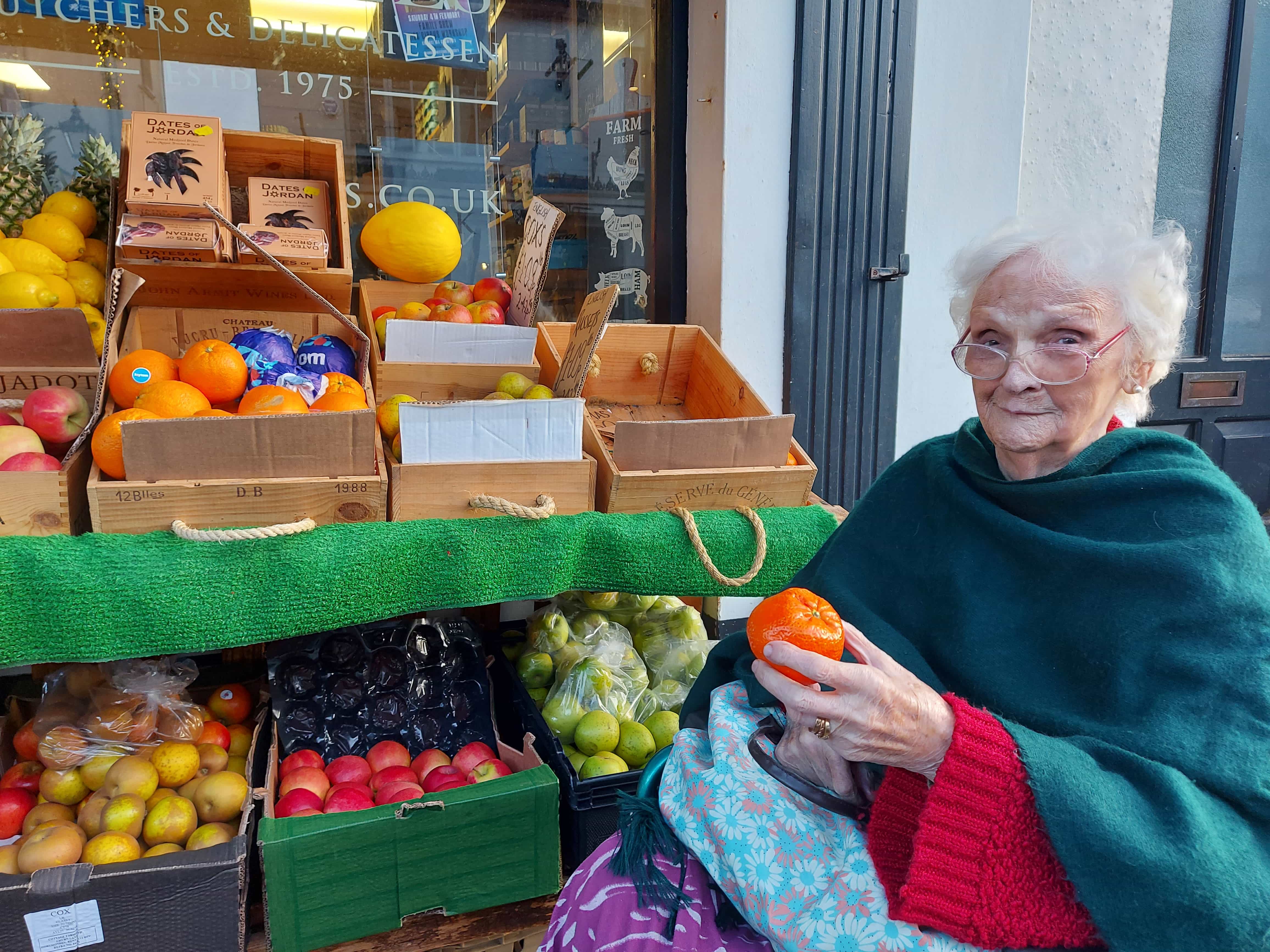 Resident with holding fruit on her stroll