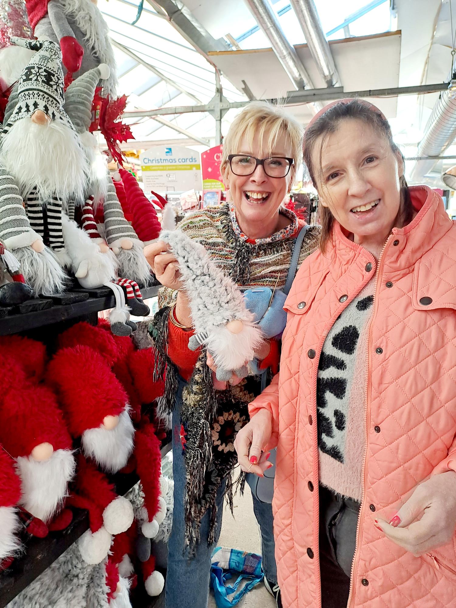 Lesley and Heather with fluffy socks and santa