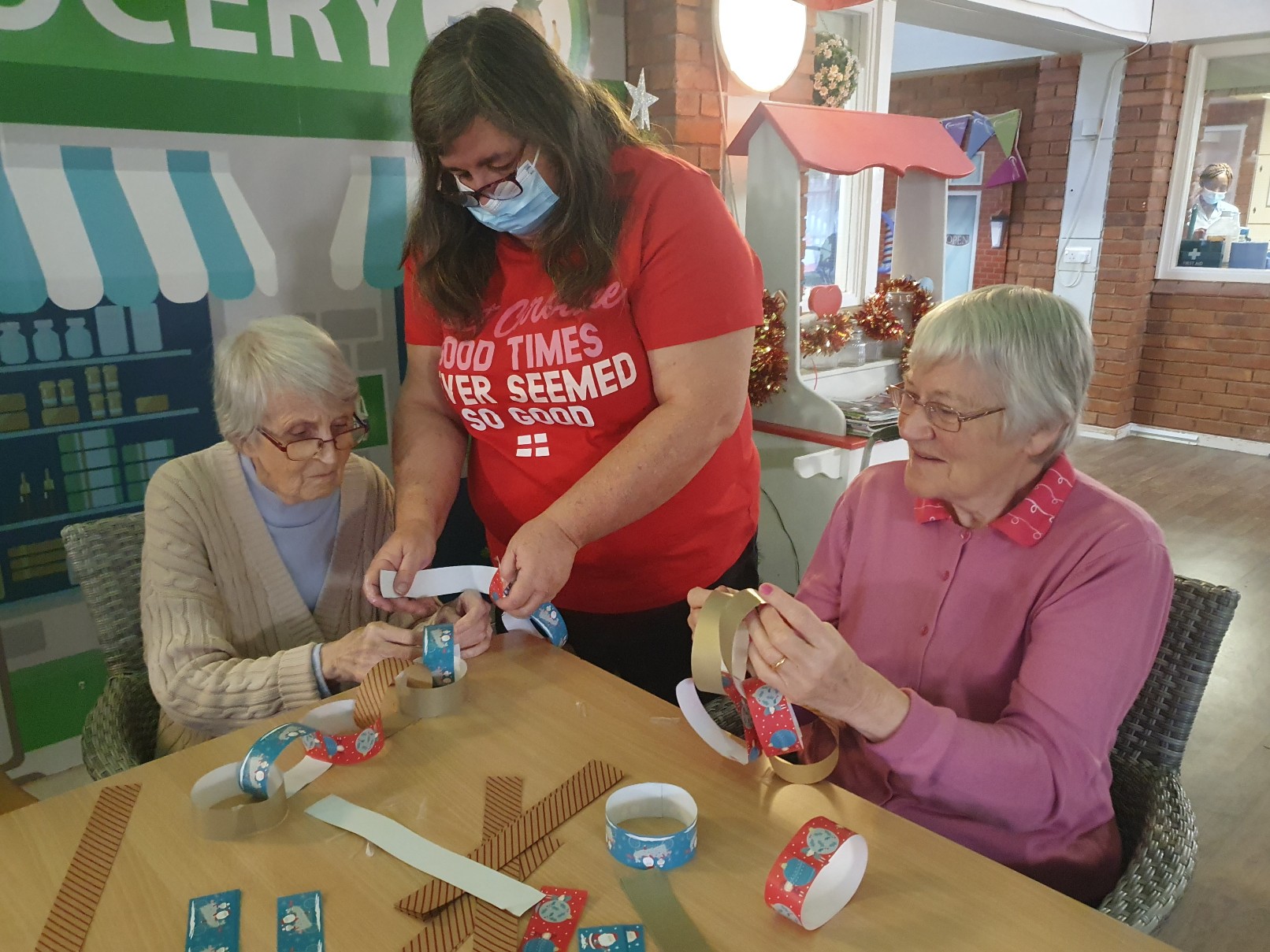 residents and employee making a wreath